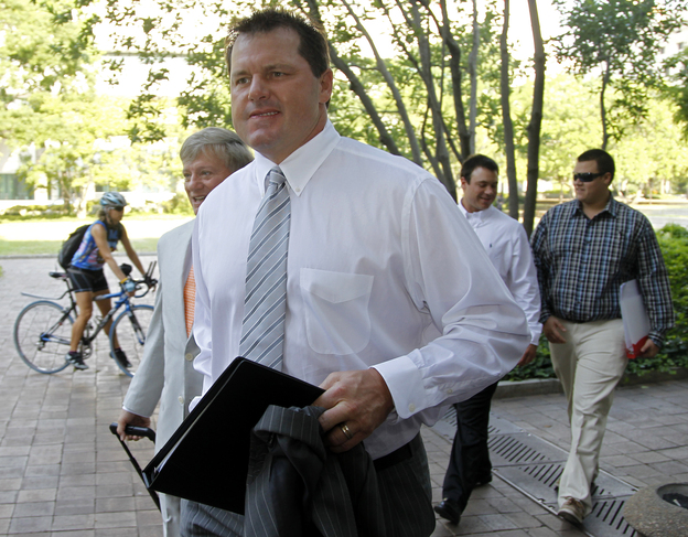 Former Major League Baseball pitcher Roger Clemens, accompanied by his attorney Rusty Hardin, left, arrives at federal court in Washington on Monday.