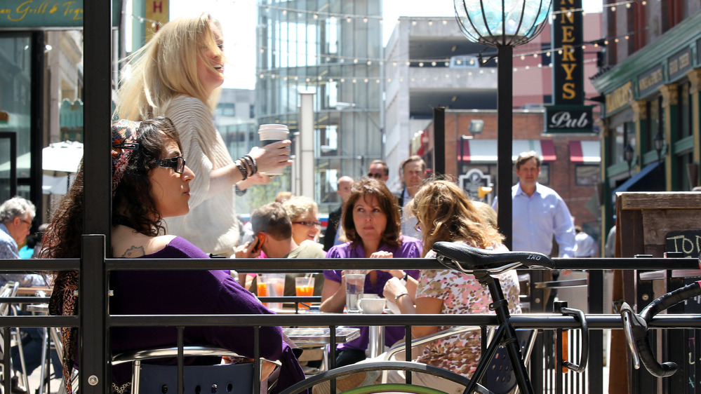 Outdoor dining spaces are filled on a warm spring day on E. 4th Street in downtown Cleveland. Like many former industrial towns, downtown Cleveland has seen a revival in the last few years to become an urban hotspot.