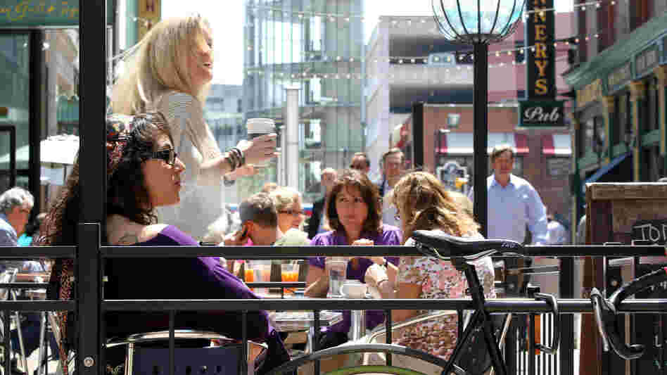 Outdoor dining spaces are filled on a warm spring day on E. 4th Street in downtown Cleveland. Like many former industrial towns, downtown Cleveland has seen a revival in the last few years to become an urban hotspot.