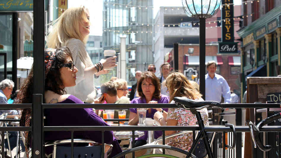 Outdoor dining spaces are filled on a warm spring day on E. 4th Street in downtown Cleveland. Like many former industrial towns, downtown Cleveland has seen a revival in the last few years to become an urban hotspot.