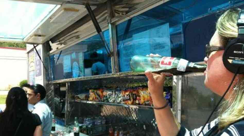 Taking a sip of the official drink of the food truck movement, Mexican Coke