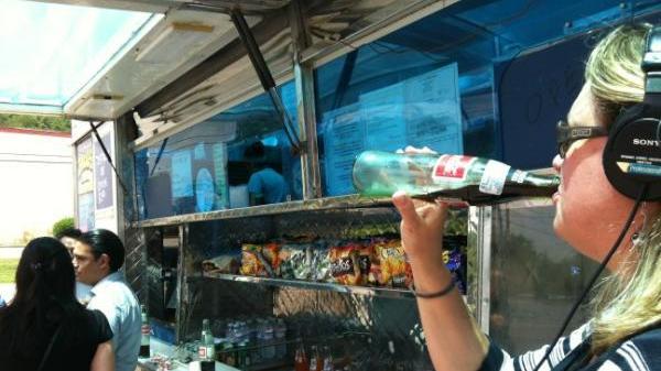 Taking a sip of the official drink of the food truck movement, Mexican Coke
