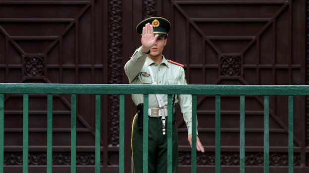 A Chinese paramilitary guard gestures outside the North Korean Embassy in Beijing on May 17. Tensions between the two countries are rising after unidentified North Koreans hijacked three Chinese fishing boats and demanded ransom, before releasing the vessels and their crew.