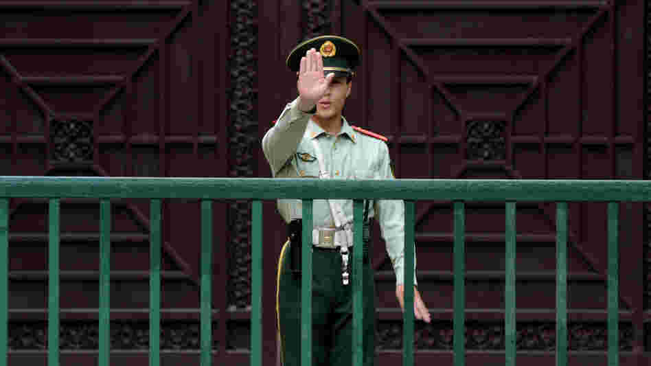 A Chinese paramilitary guard gestures outside the North Korean Embassy in Beijing on May 17. Tensions between the two countries are rising after unidentified North Koreans hijacked three Chinese fishing boats and demanded ransom, before releasing the vessels and their crew.