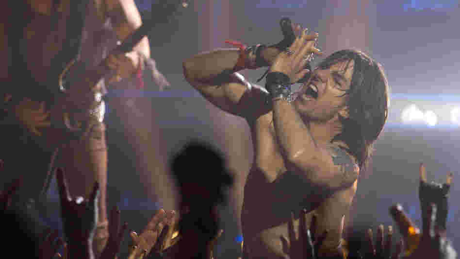 Tom Cruise plays Stacee Jaxx, an egomaniacal rock star, in Rock of Ages. The movie features several supporting performances — including ones from Alec Baldwin, Bryan Cranston and Catherine Zeta-Jones — that outshine the main plot. Tom Cruise plays Stacee Jaxx, an egomaniacal rock star, in Rock of Ages. The movie features several supporting performances — including ones from Alec Baldwin, Bryan Cranston and Catherine Zeta-Jones — that outshine the main plot.