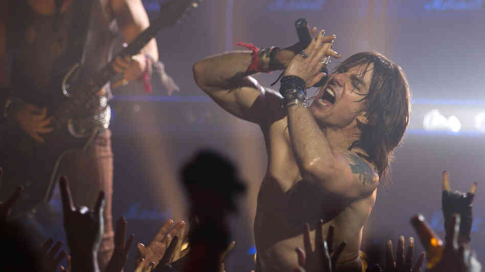 Tom Cruise plays Stacee Jaxx, an egomaniacal rock star, in Rock of Ages. The movie features several supporting performances — including ones from Alec Baldwin, Bryan Cranston and Catherine Zeta-Jones — that outshine the main plot. Tom Cruise plays Stacee Jaxx, an egomaniacal rock star, in Rock of Ages. The movie features several supporting performances — including ones from Alec Baldwin, Bryan Cranston and Catherine Zeta-Jones — that outshine the main plot.