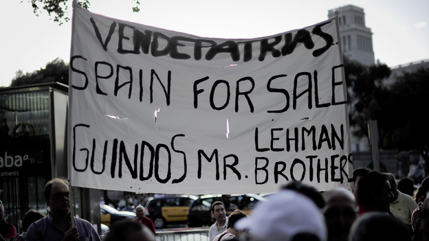 Protesters rally against a bailout package for Spain in front of a Bank of Spain building in Barcelona on Monday. The demonstrators think the bailout will bring only greater hardship.
