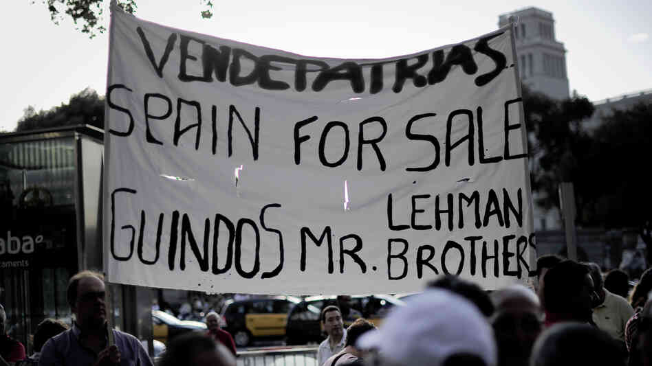 Protesters rally against a bailout package for Spain in front of a Bank of Spain building in Barcelona on Monday. The demonstrators think the bailout will bring only greater hardship.