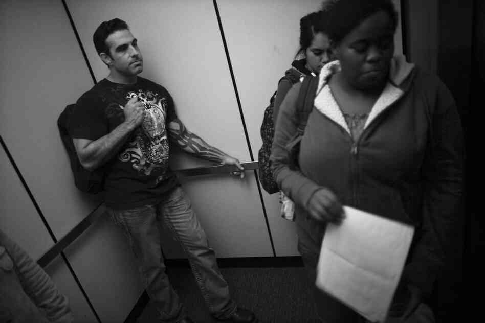 Jay Blake (left), who served multiple tours in Iraq as a Marine, rides the elevator with his fellow students in the library at Sierra College in Rocklin, Calif. Blake, who has struggled since returning home, says he finally settled into his studies with the help of Catherine Morris, an academic adviser who works with the vets on campus.