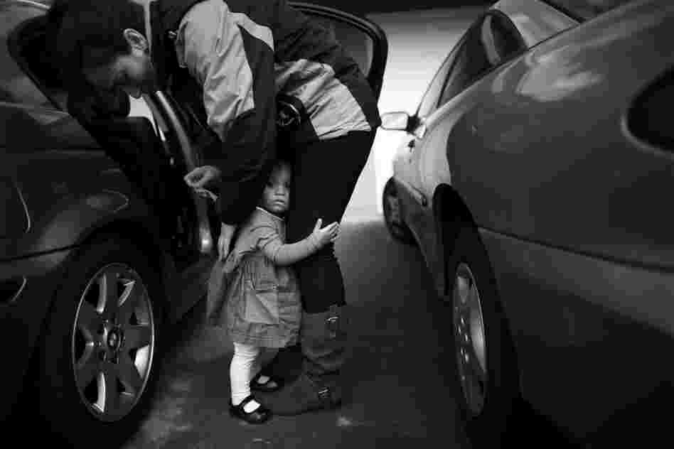 Crystal Turner, a Marine veteran now attending classes at Sierra College, helps her 1 1/2-year-old daughter, Marley Rose, out of a car. Turner is balancing classes and working at the vets center on campus with being a full-time mother.