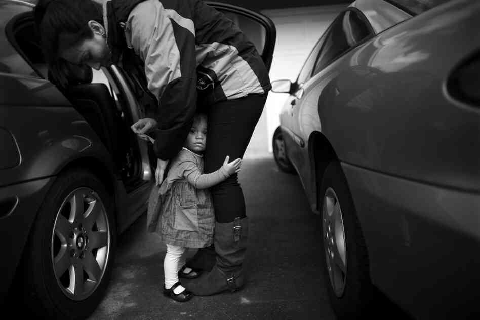 Crystal Turner, a Marine veteran now attending classes at Sierra College, helps her 1 1/2-year-old daughter, Marley Rose, out of a car. Turner is balancing classes and working at the vets center on campus with being a full-time mother.