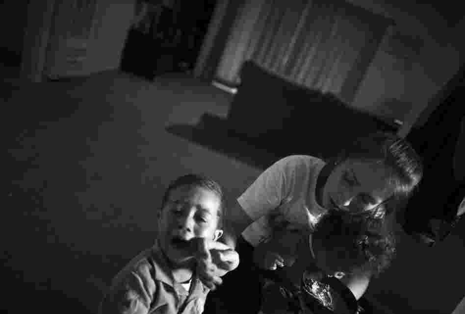 Turner holds Marley Rose while she comforts her 3-year-old son, Michael.