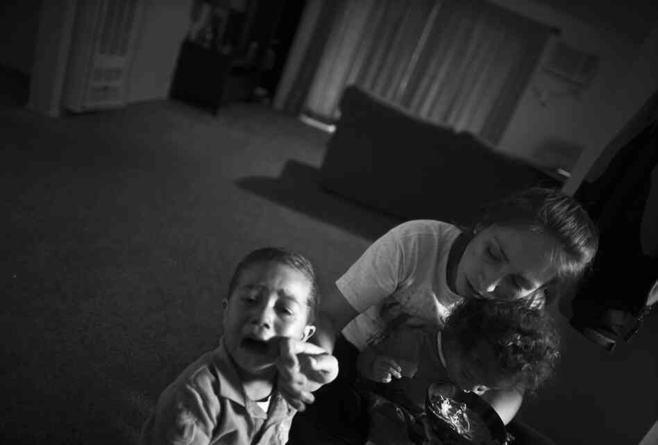 Turner holds Marley Rose while she comforts her 3-year-old son, Michael.
