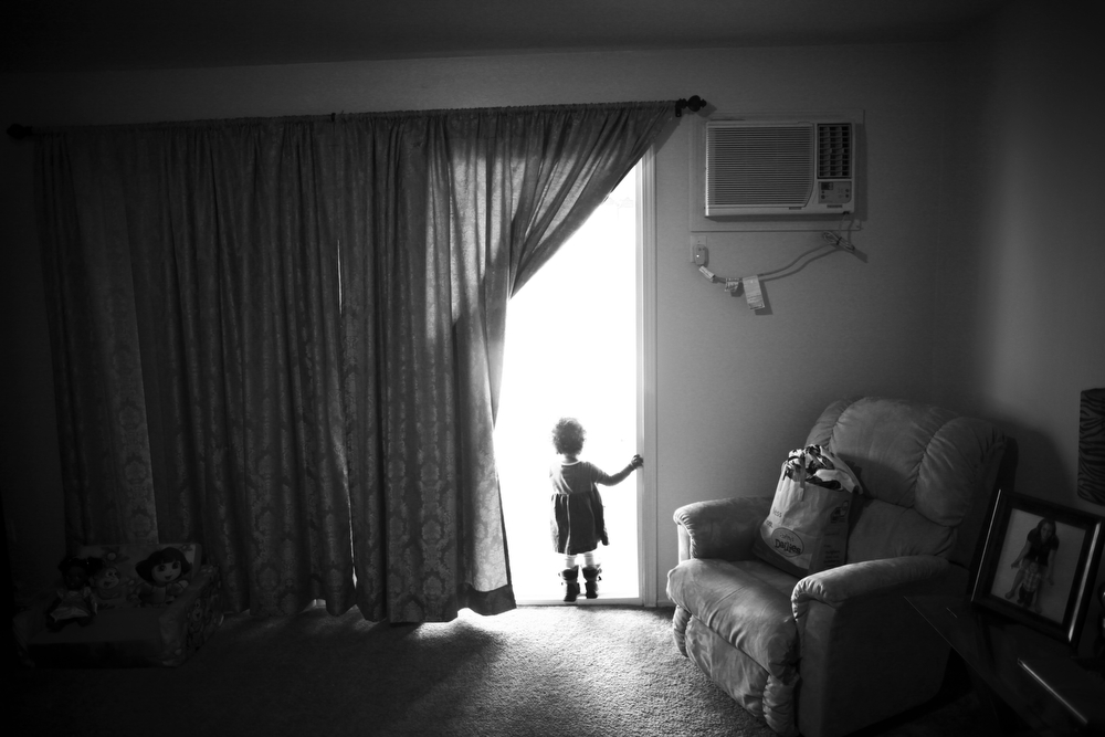 Marley Rose looks outside to the backyard for her mother.
