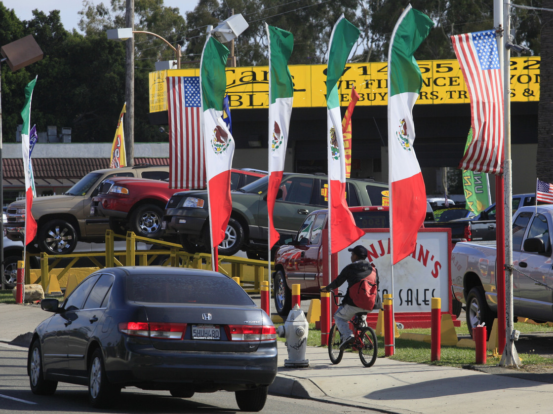 U.S. and Mexican flags decorate an auto shop in Santa Ana, Calif., June 2011.