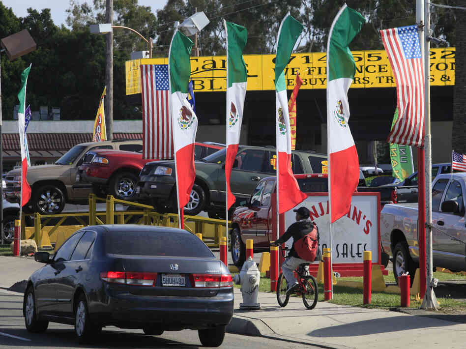 U.S. and Mexican flags decorate an auto shop in Santa Ana, Calif., June 2011.