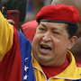 Venezuela's President Hugo Chavez arrives atop a truck at the elections office in Caracas on Monday. Chavez addressed thousands of supporters as he formalized his re-election bid. Chavez's younger daughter Rosines is by his side, and on his right is his brother Adan.