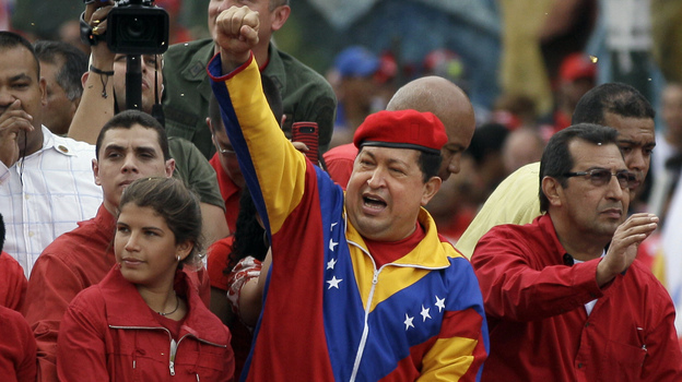 Venezuela's President Hugo Chavez arrives atop a truck at the elections office in Caracas on Monday. Chavez addressed thousands of supporters as he formalized his re-election bid. Chavez's younger daughter Rosines is by his side, and on his right is his brother Adan.