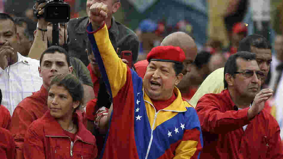 Venezuela's President Hugo Chavez arrives atop a truck at the elections office in Caracas on Monday. Chavez addressed thousands of supporters as he formalized his re-election bid. Chavez's younger daughter Rosines is by his side, and on his right is his brother Adan.