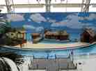 At Berlin's Tropical Islands, sandy beaches line the tropical sea, and a backdrop of a sky makes visitors forget they're inside a dome...almost. At Berlin's Tropical Islands, sandy beaches line the tropical sea, and a backdrop of a sky makes visitors forget they're inside a dome...almost.