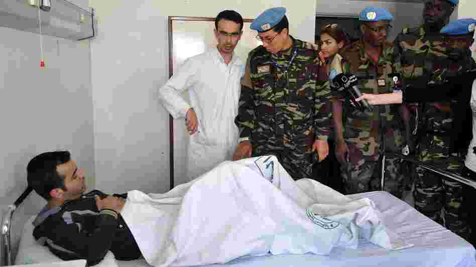 Members of the U.N. observers mission in Syria visit wounded soldiers and policemen at Tishreen Military Hospital in Damascus on May 23. Casualties among Syrian government forces are rising sharply.