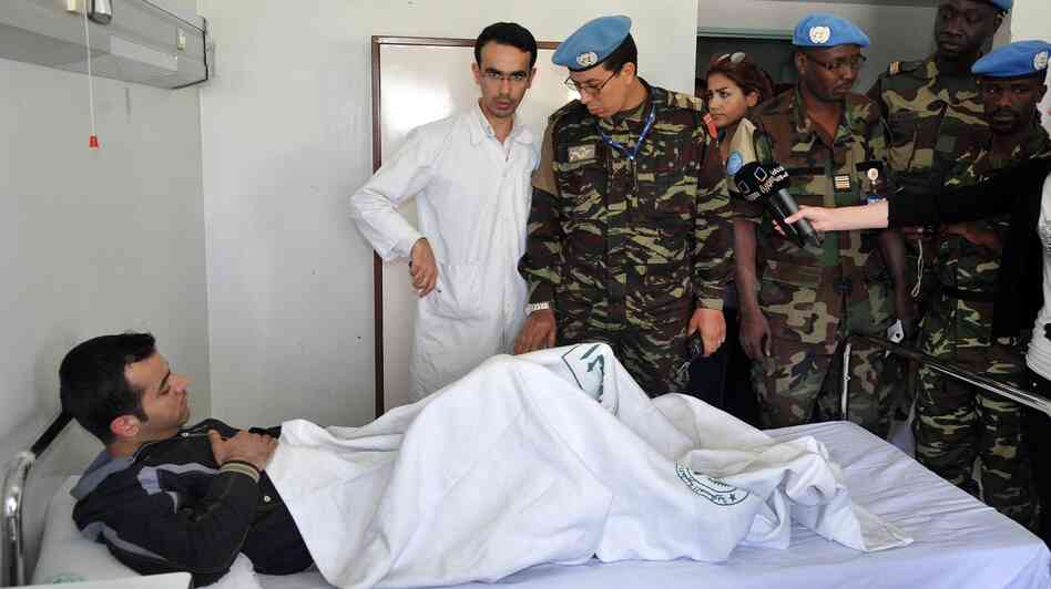 Members of the U.N. observers mission in Syria visit wounded soldiers and policemen at Tishreen Military Hospital in Damascus on May 23. Casualties among Syrian government forces are rising sharply.