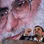 Iranian President Mahmoud Ahmadinejad delivers a speech under a portrait of Iran's supreme leader, Ayatollah Ali Khamenei, on June 2. The supreme leader has said repeatedly that nuclear weapons are un-Islamic and Iran will not pursue them. But in the West, many are skeptical.