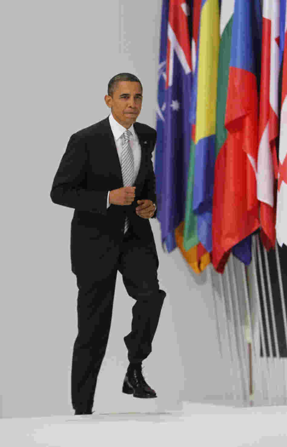 President Obama climbs the podium to give a media briefing at the end of a NATO summit in Lisbon, Portugal, on Nov. 20, 2010.