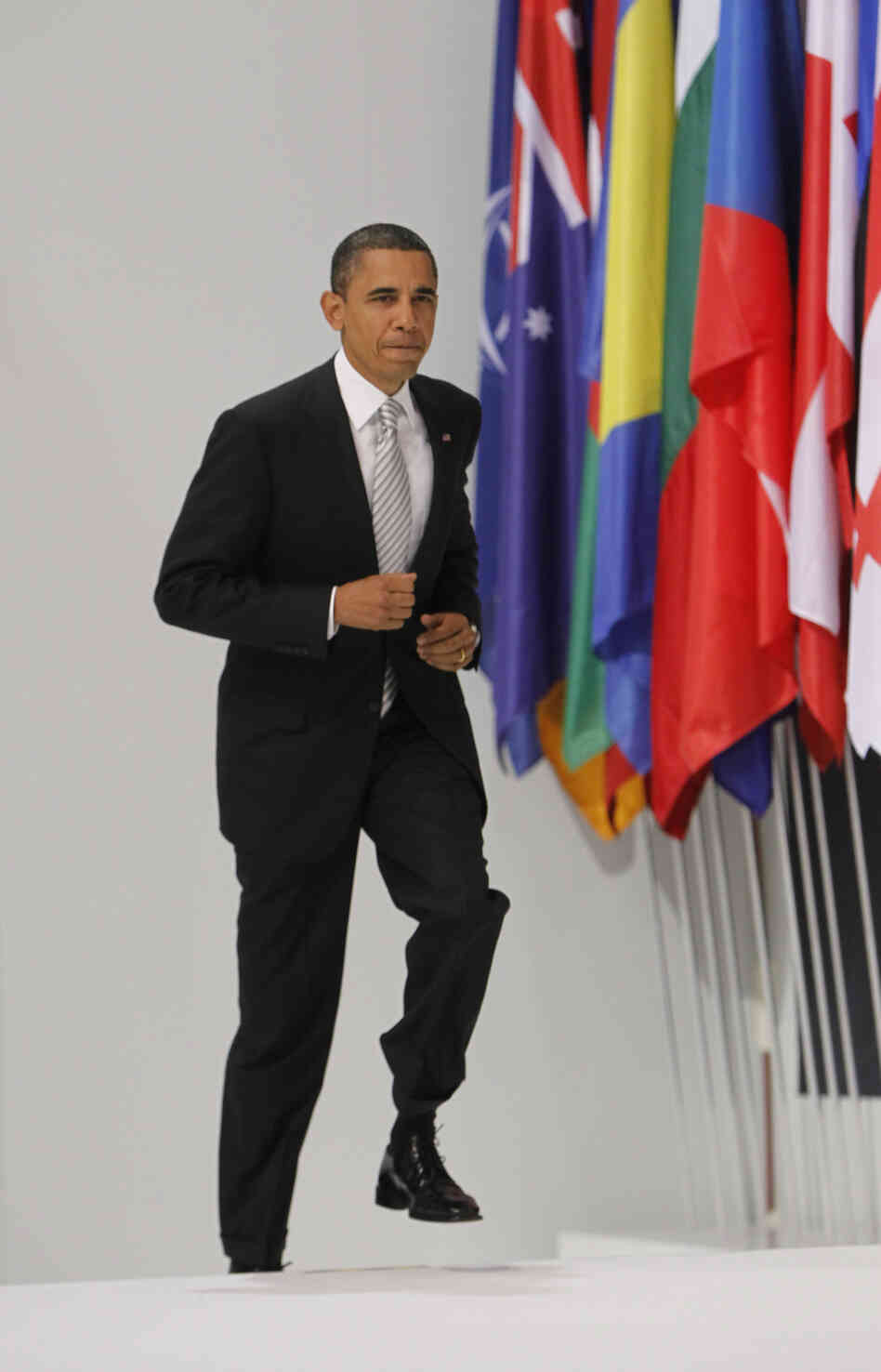 President Obama climbs the podium to give a media briefing at the end of a NATO summit in Lisbon, Portugal, on Nov. 20, 2010.