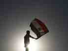 An Egyptian protester waves his national flag at sunset during a demonstration in Cairo's landmark Tahrir Square on June 5, 2012 to protest against verdicts handed down in ex-president Hosni Mubarak's murder trial.