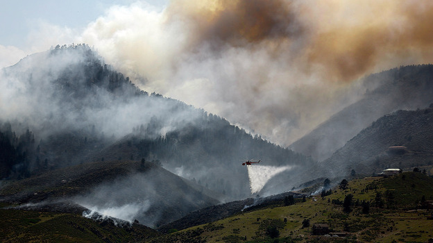 Near Laporte, Colo., earlier this week, smoke billowed from the mountains. In the foreground: A helicopter was dumping water on a hotspot.