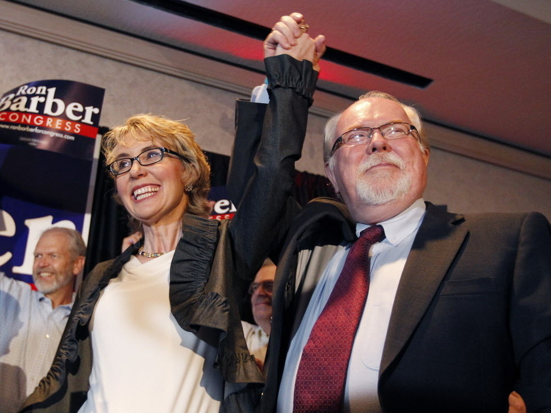 Former Rep. Gabrielle Giffords, left, celebrates with Ron Barber after he won Tuesday's special election in Arizona to serve the remaining seven months of her term. Like Giffords, Barber is a Democrat. He's also a former Giffords aide.