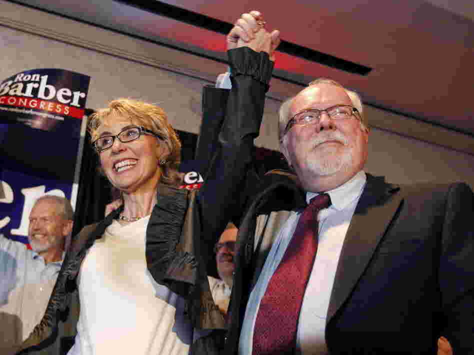Former Rep. Gabrielle Giffords, left, celebrates with Ron Barber after he won Tuesday's special election in Arizona to serve the remaining seven months of her term. Like Giffords, Barber is a Democrat. He's also a former Giffords aide.