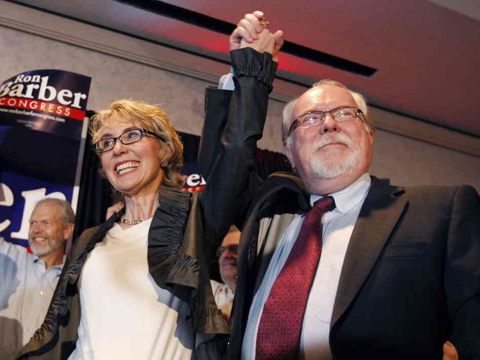 Former Rep. Gabrielle Giffords, left, celebrates with Ron Barber after he won Tuesday's special election in Arizona to serve the remaining seven months of her term. Like Giffords, Barber is a Democrat. He's also a former Giffords aide.