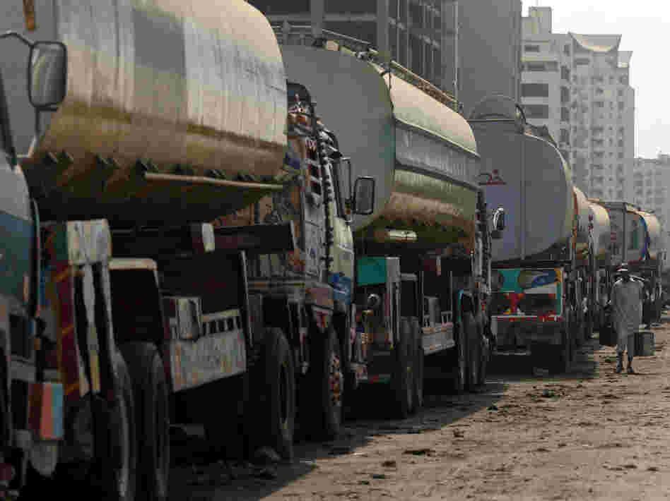 Fuel trucks are backed up in Karachi, Pakistan. U.S. negotiators spent more than a month talking with Pakistan about reopening supply routes from Pakistan to Afghanistan. Pakistan reportedly wants about $3,000 for each trip, while the U.S. is reportedly offering about $1,000.