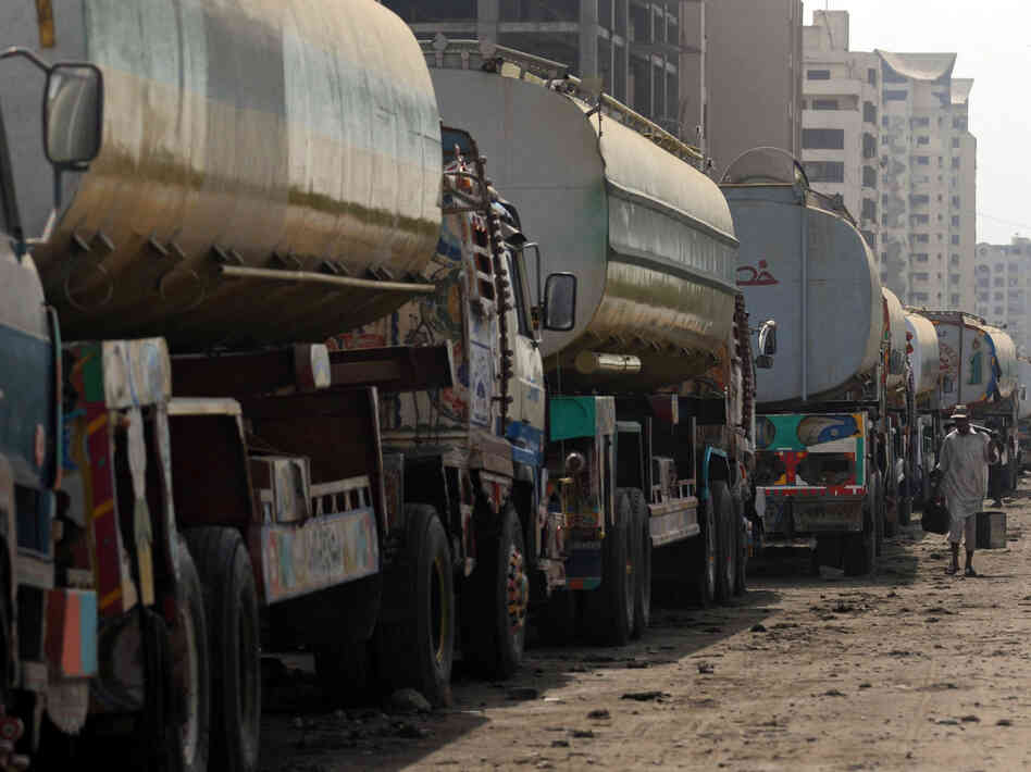 Fuel trucks are backed up in Karachi, Pakistan. U.S. negotiators spent more than a month talking with Pakistan about reopening supply routes from Pakistan to Afghanistan. Pakistan reportedly wants about $3,000 for each trip, while the U.S. is reportedly offering about $1,000.