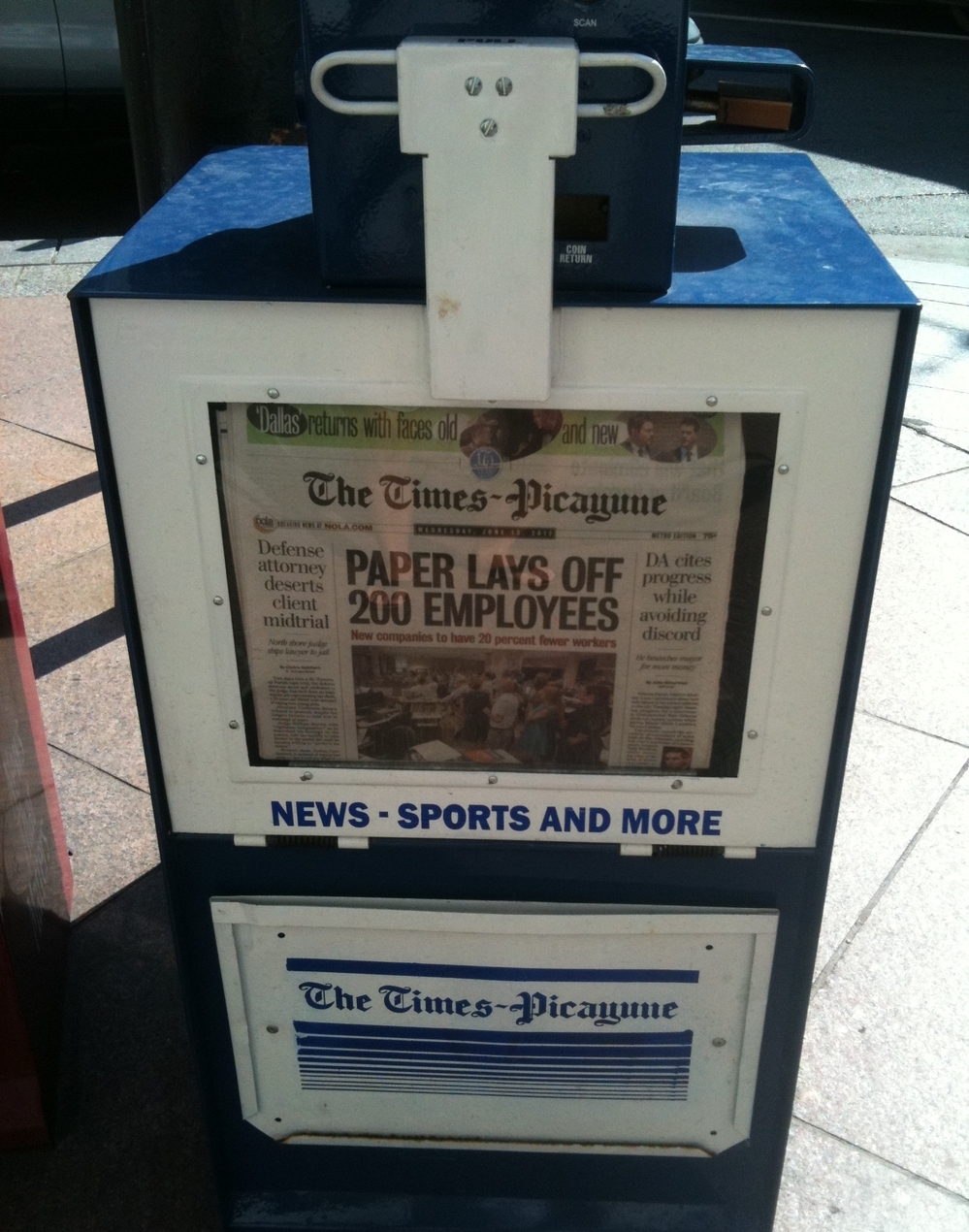 A New Orleans newspaper stand holds copies of Wednesday's Times-Picayune, which announced layoffs for 200 employees.