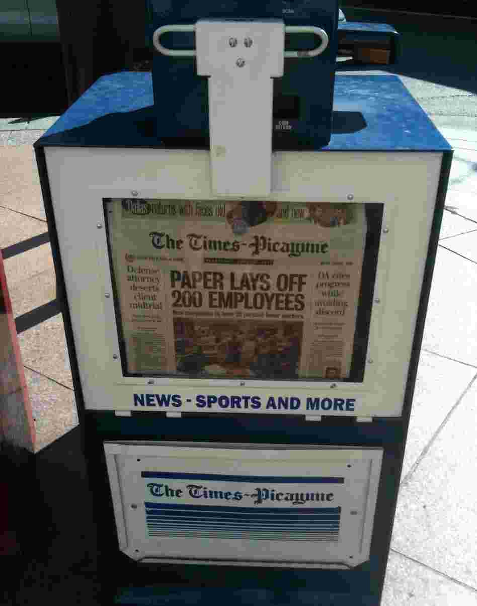 A New Orleans newspaper stand holds copies of Wednesday's Times-Picayune, which announced layoffs for 200 employees.