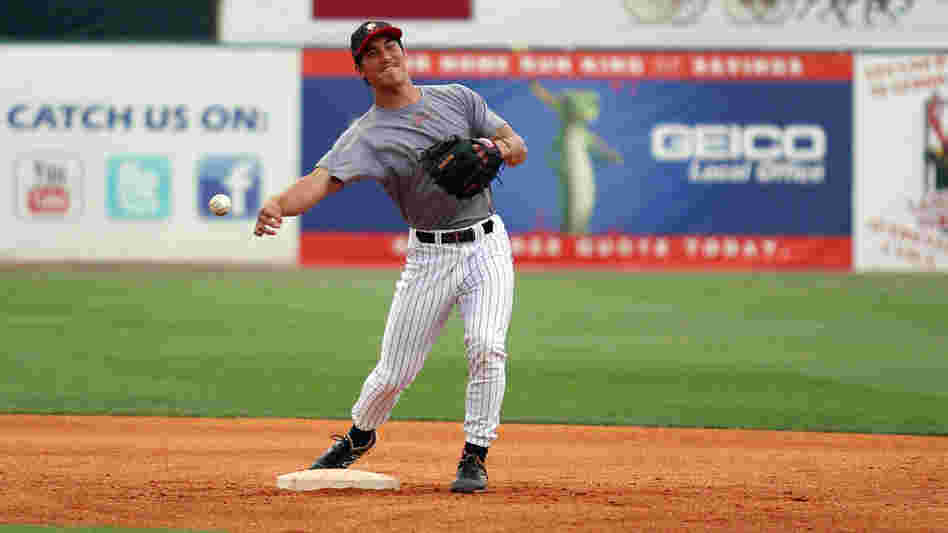 Tyler Saladino, 22, makes a throw from second base during warm-ups with the AA Birmingham Barons.