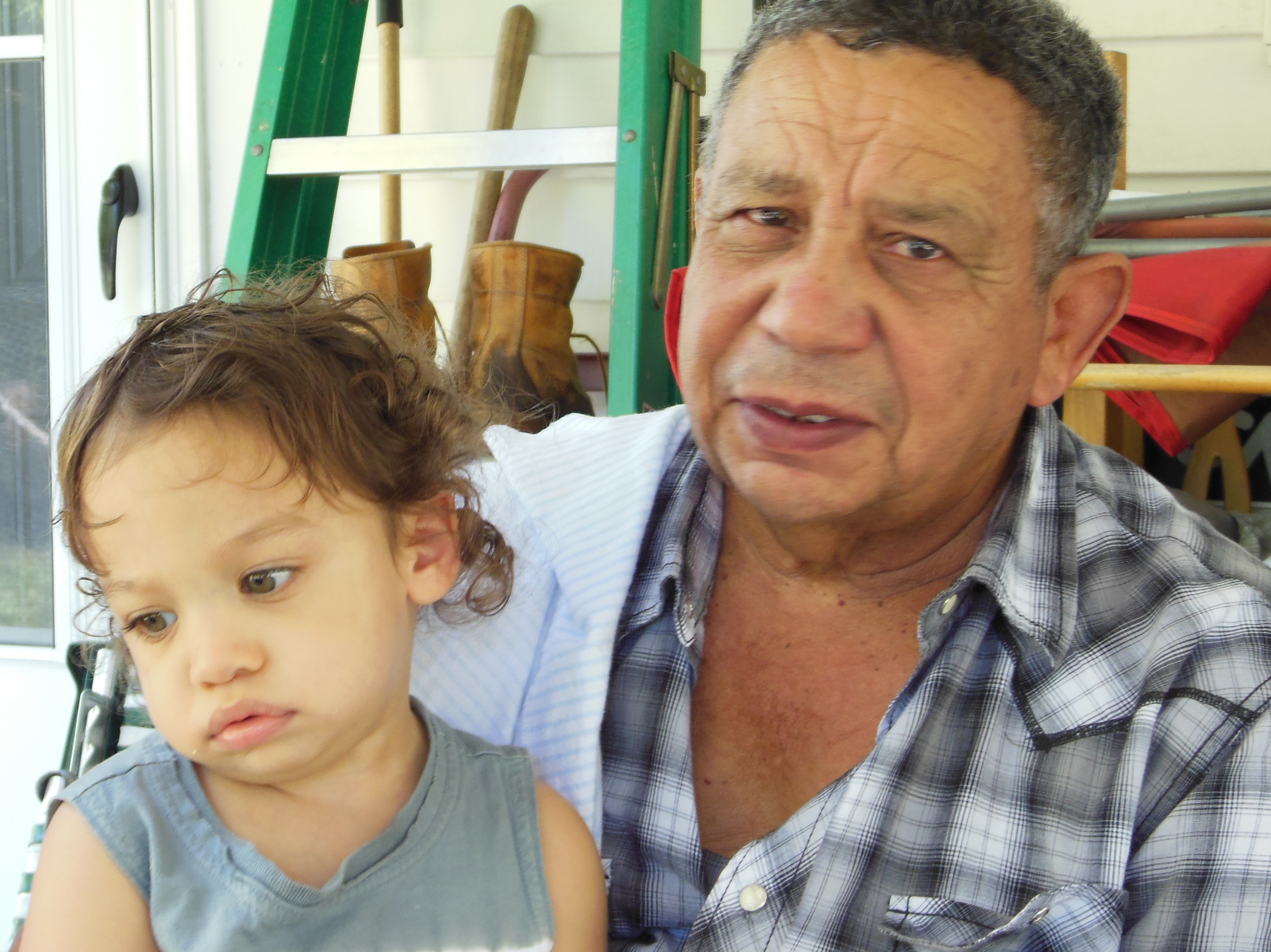 Angel Cruz with grandson Christopher. Cruz came to the U.S. from the Dominican Republic in 1964.