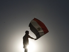 An Egyptian protester waves his national flag in Cairo. An Egyptian protester waves his national flag in Cairo.