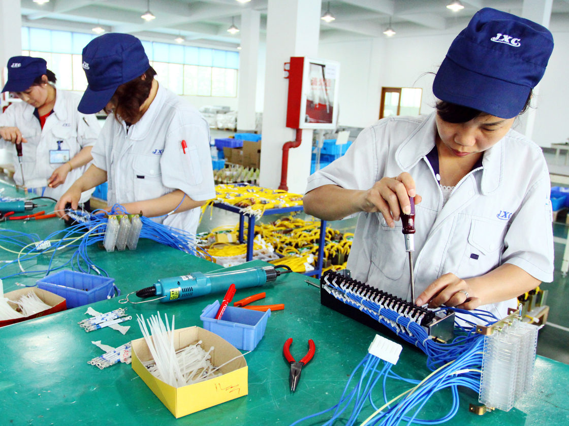 Workers assemble computers at a factory in Jiashan, east China's Zhejiang province.