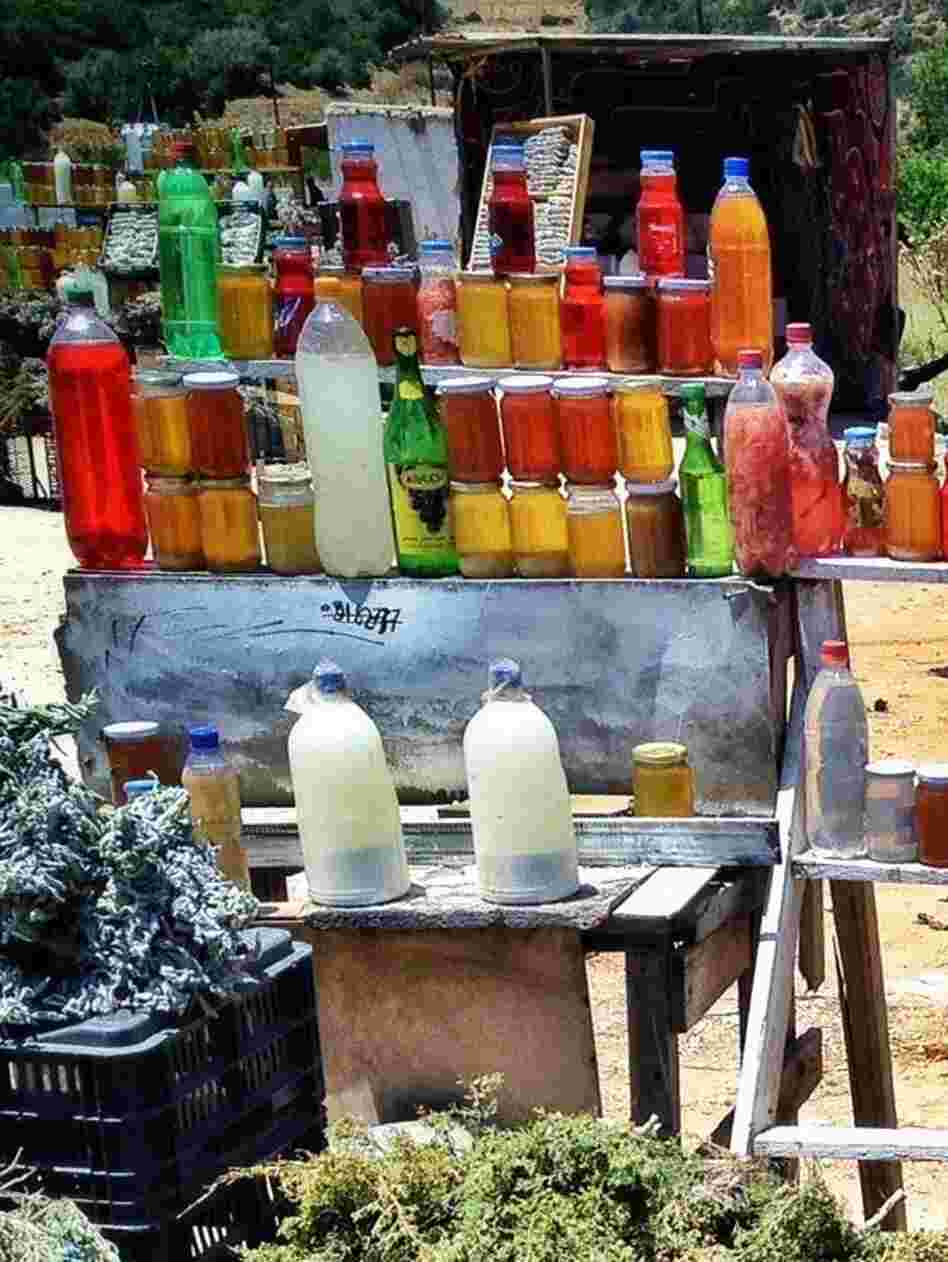Jars of honey and bunches of herbs at a roadside stall near Libya's Green Mountains.
