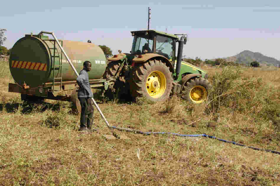 The Quifel Natural Resources farm near Ruasse sends tanks to draw irrigation water from the stream that also supplies the village's water.