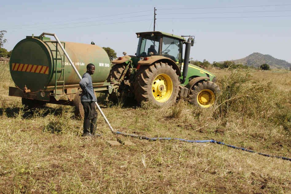 The Quifel Natural Resources farm near Ruasse sends tanks to draw irrigation water from the stream that also supplies the village's water.