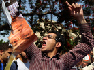 An Egyptian protester chants slogans as he holds a ripped poster of presidential candidate Ahmed Shafiq outside the Supreme Constitutional Court in Cairo today. An Egyptian protester chants slogans as he holds a ripped poster of presidential candidate Ahmed Shafiq outside the Supreme Constitutional Court in Cairo today.