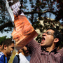 An Egyptian protester chants slogans as he holds a ripped poster of presidential candidate Ahmed Shafiq outside the Supreme Constitutional Court in Cairo today. An Egyptian protester chants slogans as he holds a ripped poster of presidential candidate Ahmed Shafiq outside the Supreme Constitutional Court in Cairo today.