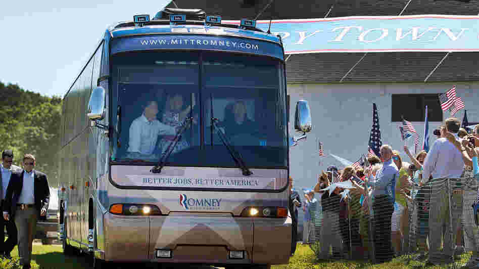 Republican presidential candidate Mitt Romney and his wife, Ann, wave from a campaign bus on Friday at Scamman Farm in Stratham, N.H.