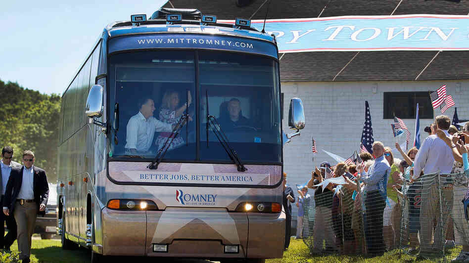 Republican presidential candidate Mitt Romney and his wife, Ann, wave from a campaign bus on Friday at Scamman Farm in Stratham, N.H.