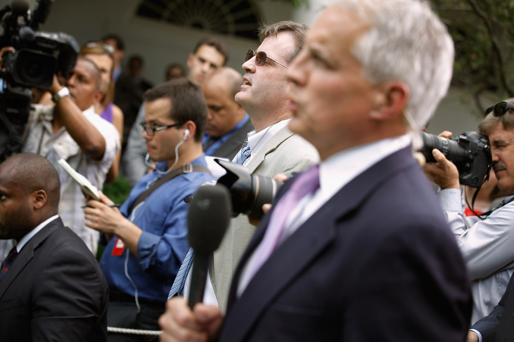 Neil Munro of the Daily Caller (center) interrupts U.S. President Barack Obama with questions as he delivered remarks in the Rose Garden at the White House.
